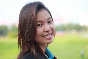 Eastern Woman smiling in open green grassy field