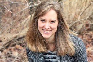 Woman smiling in front of tree